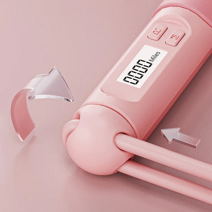 Smart jump rope with digital counter in pink showing distance on LCD screen